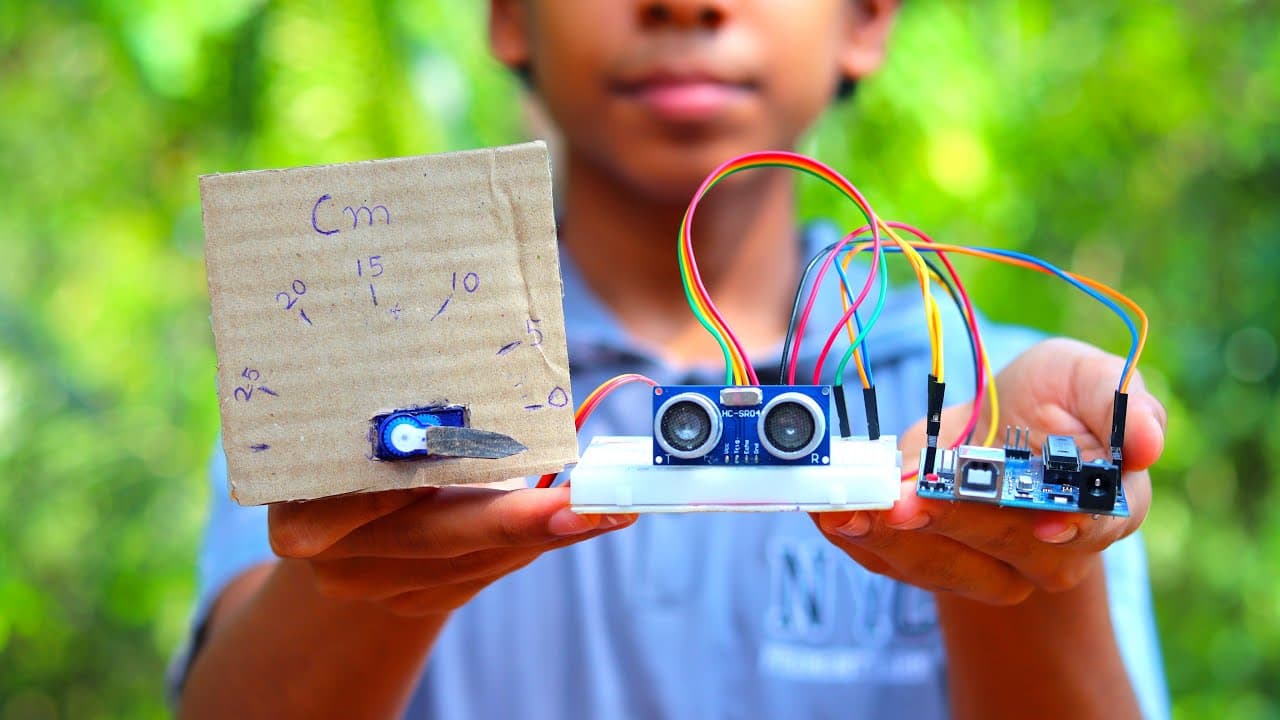 Student holding a DIY ultrasonic sensor project