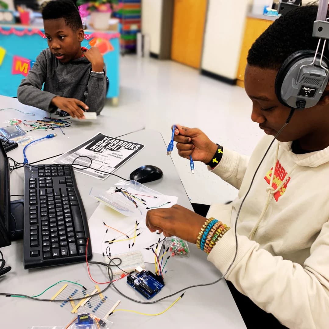 Students building electronics in a classroom